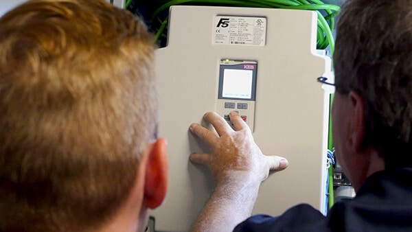 Elevator professionals checking VFD parameters on an F5 KEB Elevator Drive installation